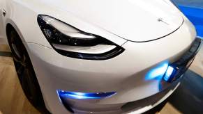A white Tesla Model S headlight close up.