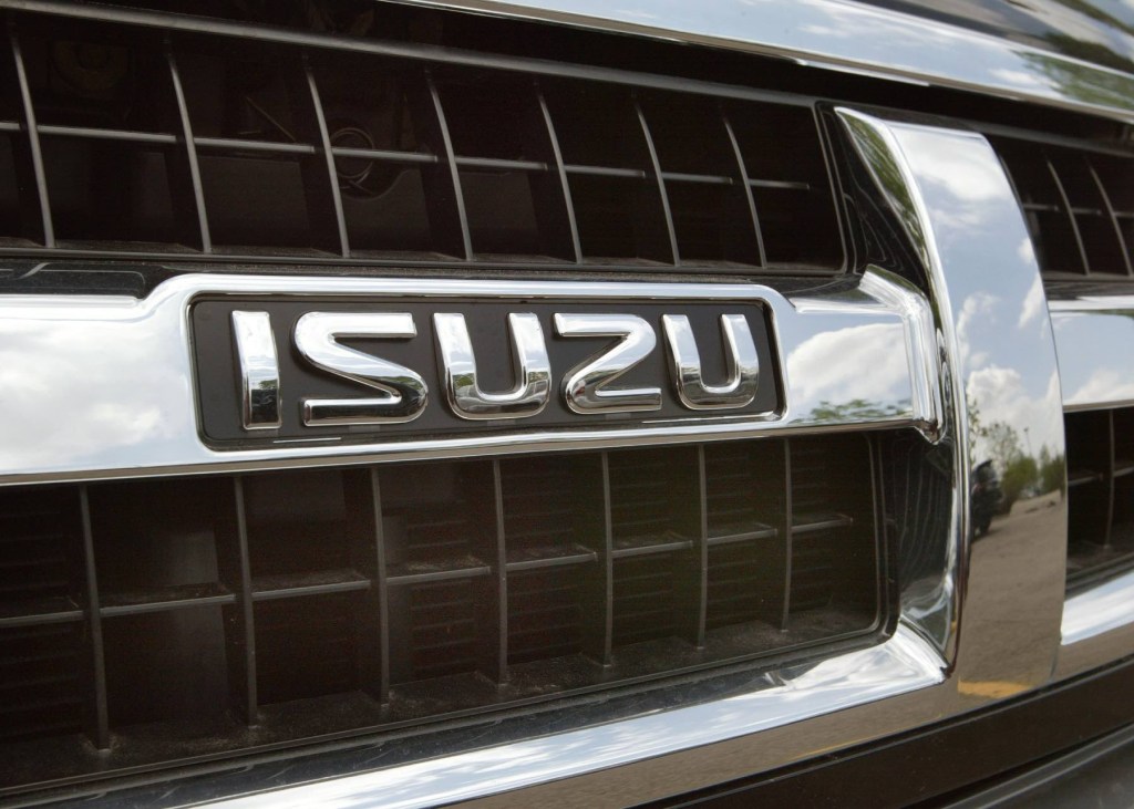 Close up image of the Isuzu logo on the grille of an SUV.