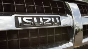 Close up image of the Isuzu logo on the grille of an SUV.