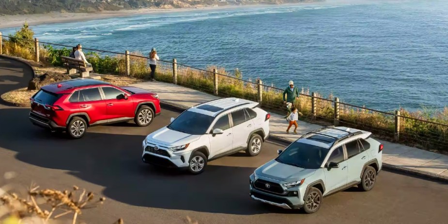 Three Toyota RAV4 small SUVs are parked side by side. 