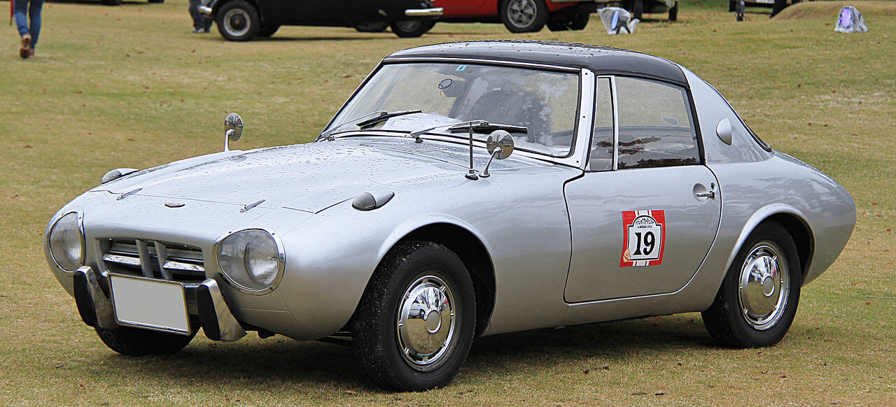 A 1965 Toyota Sports 800 in the middle of a field.