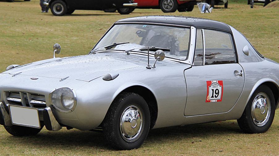 A 1965 Toyota Sports 800 in the middle of a field.