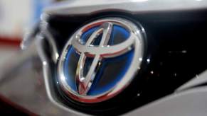 A Toyota logo, which the 2023 Toyota reliability still remains strong, on the grille of a car.