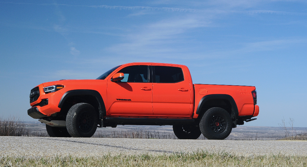 A 2023 Toyota Tacoma midsize pickup is parked with the open sky behind it.