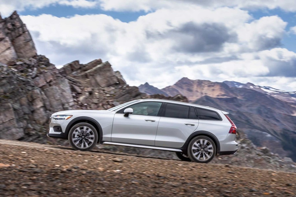Side view of a Volvo V60 Cross Country driving off-road in the mountains.