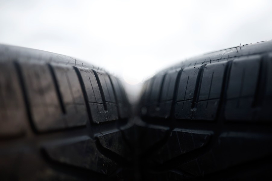 Close-up of two tires next to each other with a white background.