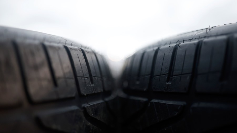 Close-up of two tires next to each other with a white background.