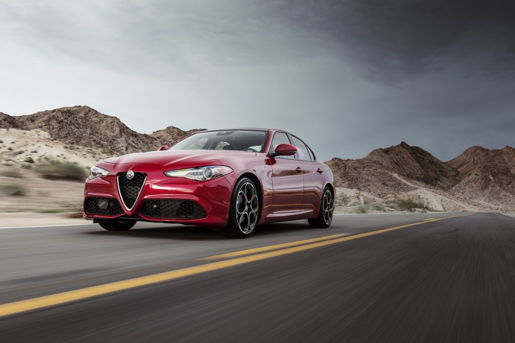 The Ti trim of the Alfa Romeo Giulia in red on a mountain road