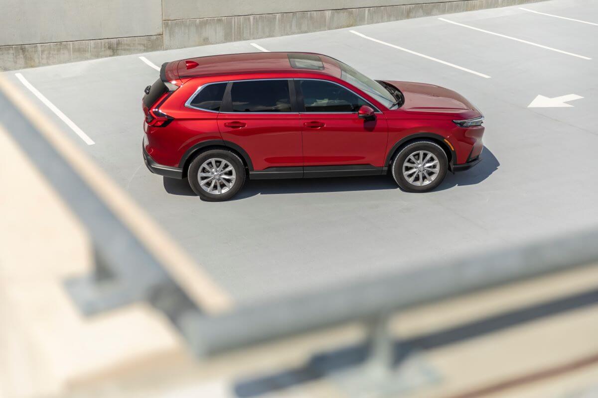 An overhead shot of a red 2023 Honda CR-V EX-L, the most reliable compact SUV model, parked on top of a parking garage