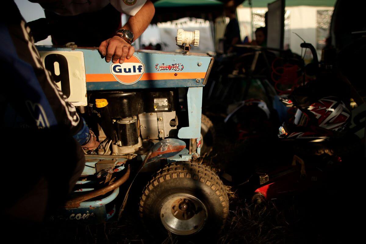 Maintenance and repairs on lawn mowers for the 12-hour Lawn Mower Endurance Race in Billinghurst, England