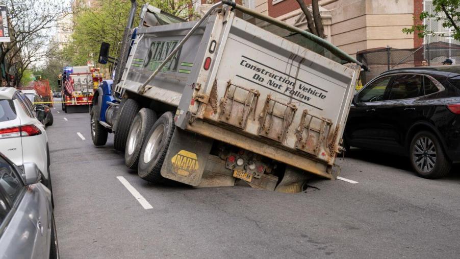 A Stanz dump truck in Manhattan, New York, falling into a sinkhole that grew out of a pothole
