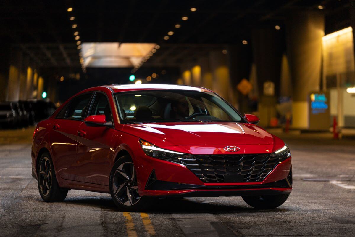 A red 2023 Hyundai Elantra compact sedan model parked in an underground tunnel