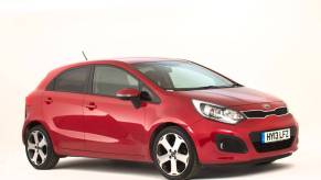 A red 2013 Kia Rio subcompact car model photo from the National Motor Museum