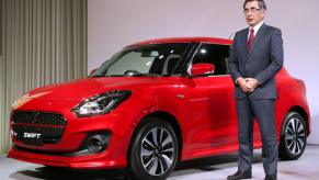 A new, red Suzuki Swift compact hatchback model introduced in Tokyo, Japan
