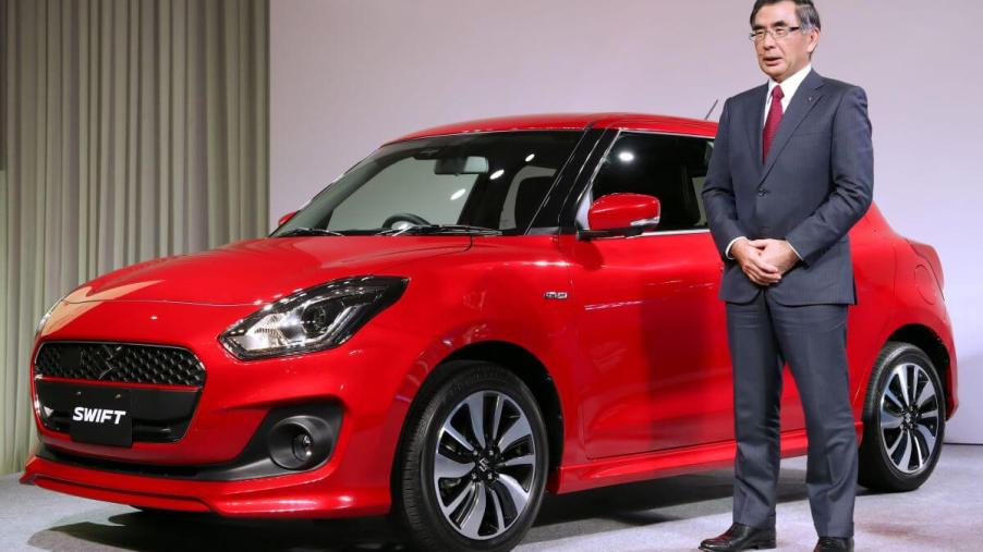 A new, red Suzuki Swift compact hatchback model introduced in Tokyo, Japan