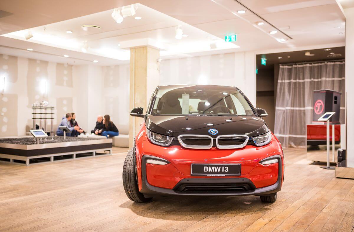 A red BMW i3 compact electric vehicle (EV) model in a Vaund store in Hanover, Germany