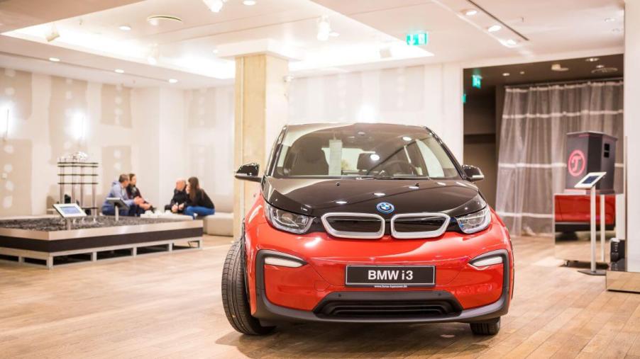 A red BMW i3 compact electric vehicle (EV) model in a Vaund store in Hanover, Germany