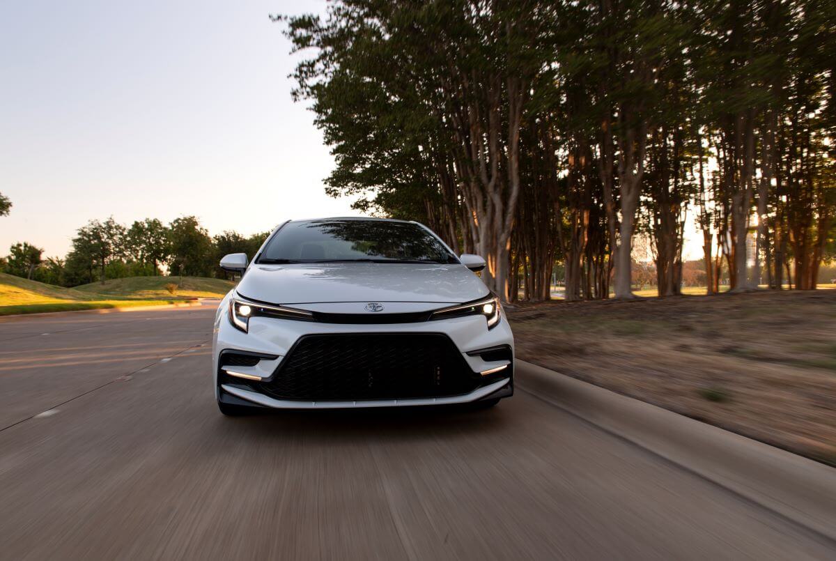A front shot of the hood and grille of a 2023 Toyota Corolla XSE compact car model in Wind Chill Pearl