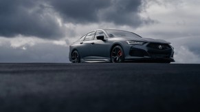 The 2023 Acura TLX Gotham Gray Edition parked with stormy clouds in the background