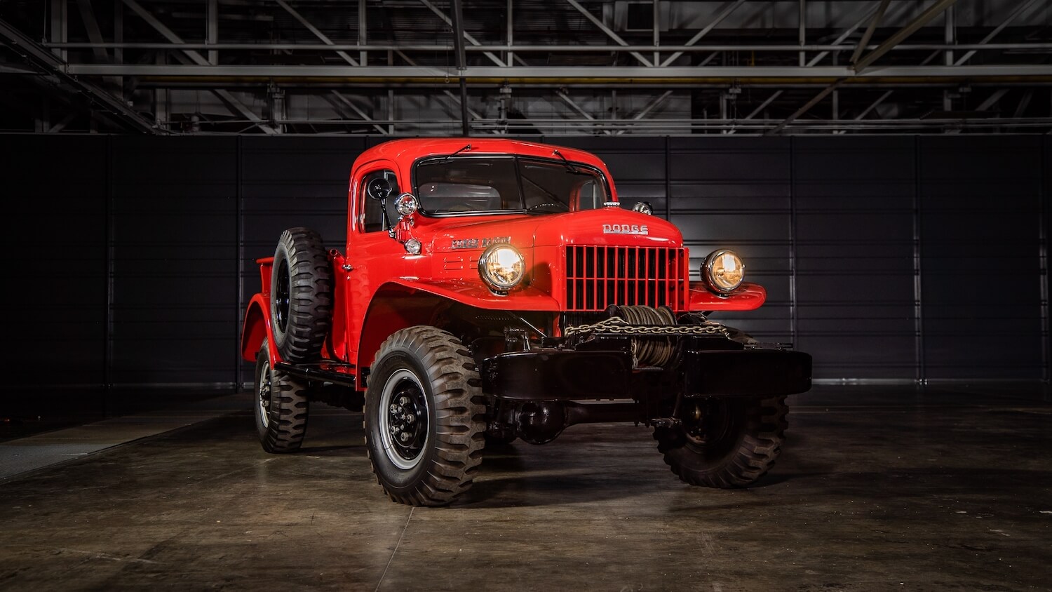 Bright red 1946 Dodge Power Wagon parked in a garage.