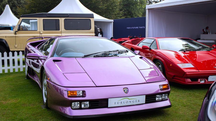 A pink 1995 Lamborghini Diablo parked in the grass
