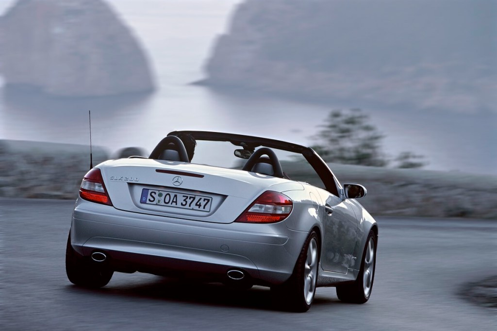 A silver Mercedes-Benz SLK200 with a manual transmission corners on a mountain pass. 