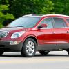 A red 2008 Buick Enclave driving on a highway.