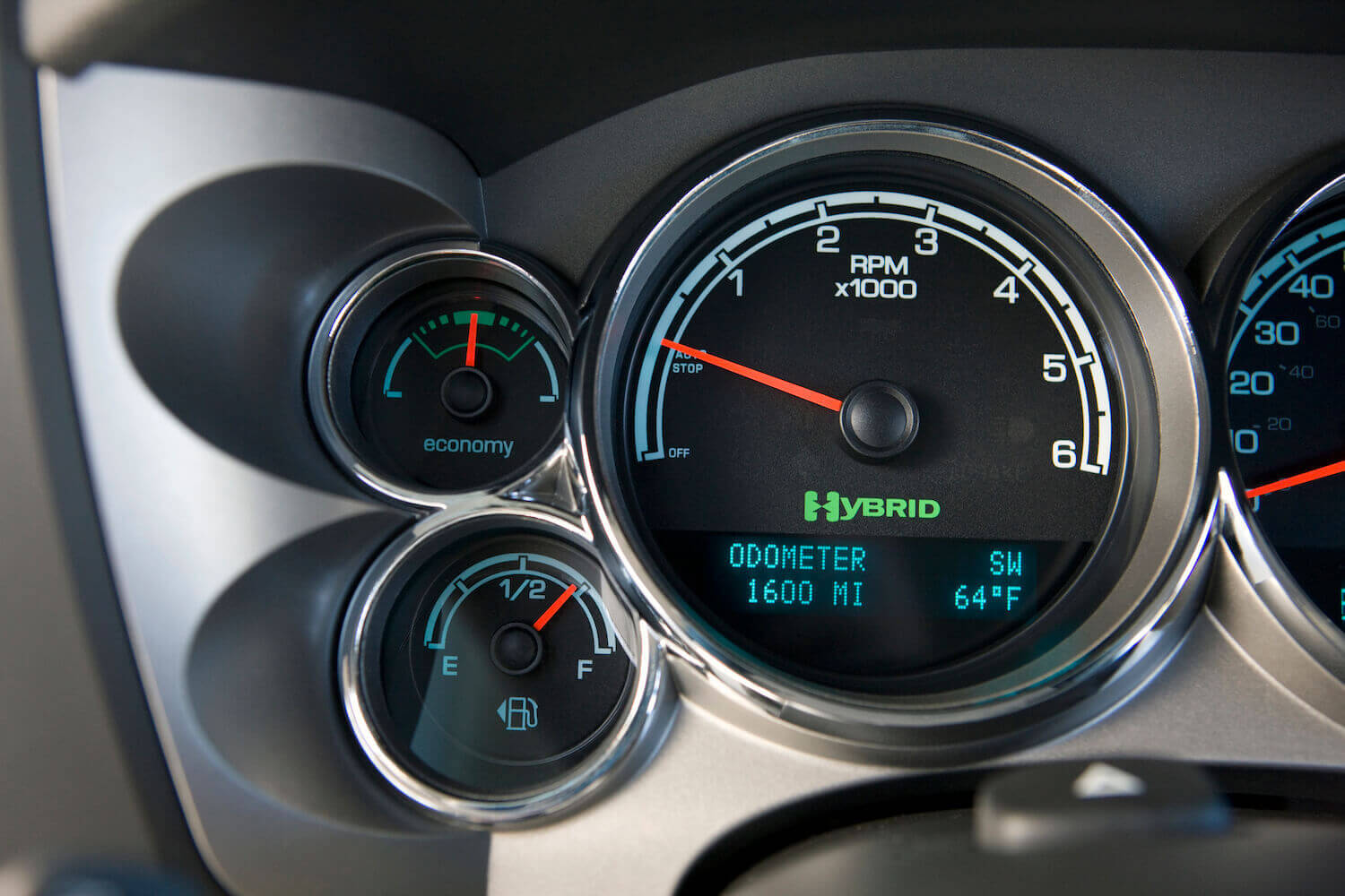 The Hybrid logo of the 2012 GMC Sierra being driven in "Eco" mode.