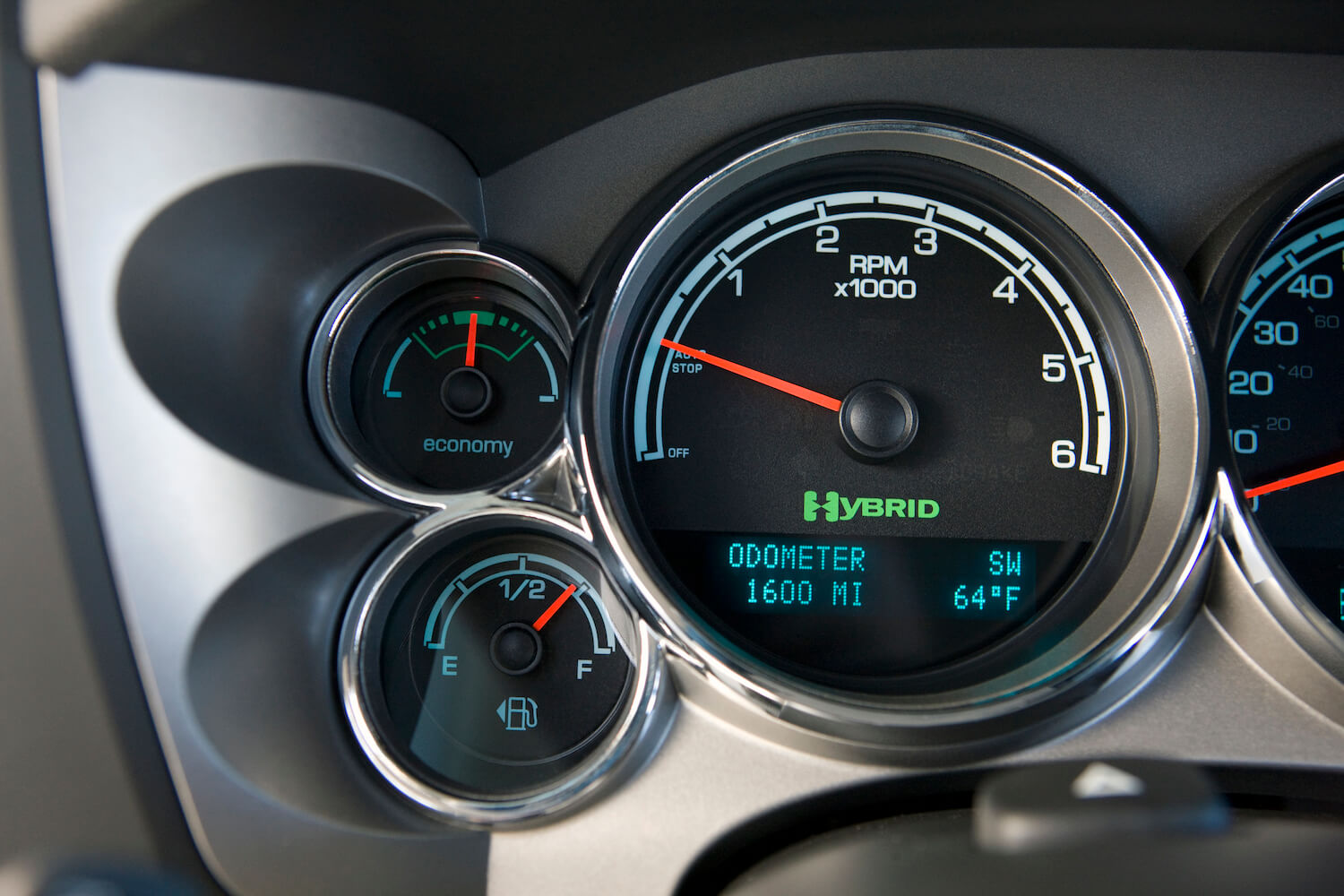 Closeup of the hybrid icon in the tachometer of a 2012 GMC Sierra full-size pickup truck with the two-mode CVT transmission.