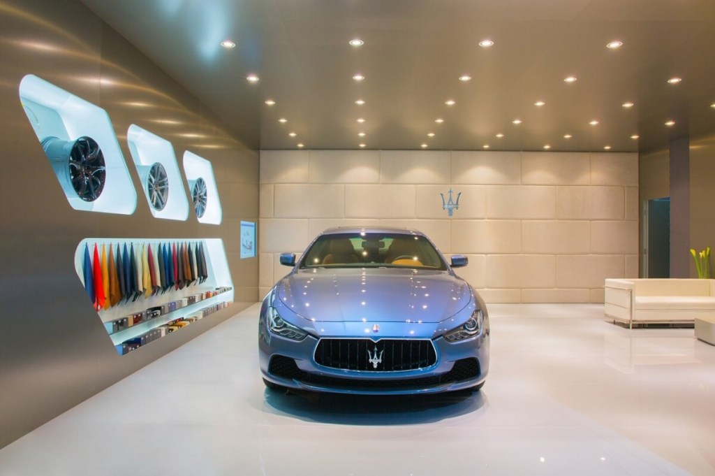A 2014 Maserati Quattroporte shows off its blue paintwork in a showroom. 