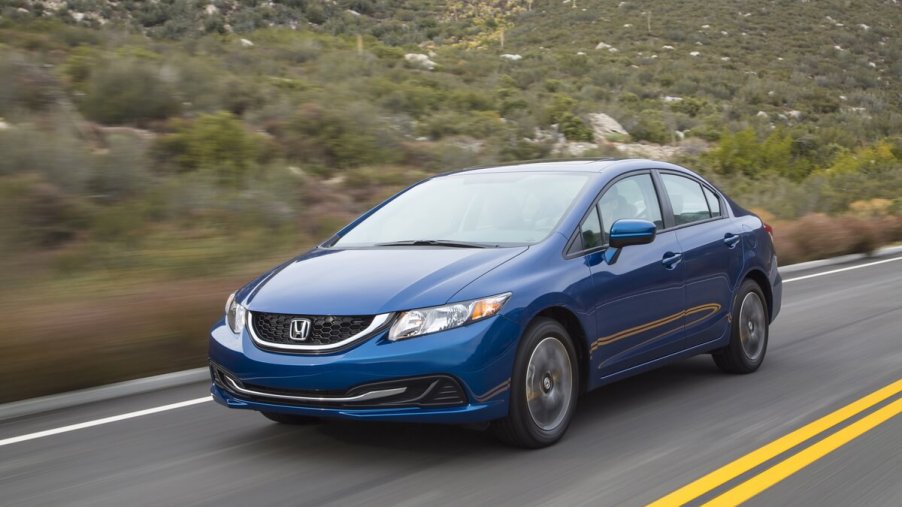 A front view of the 2014 Honda Civic driving down a road.