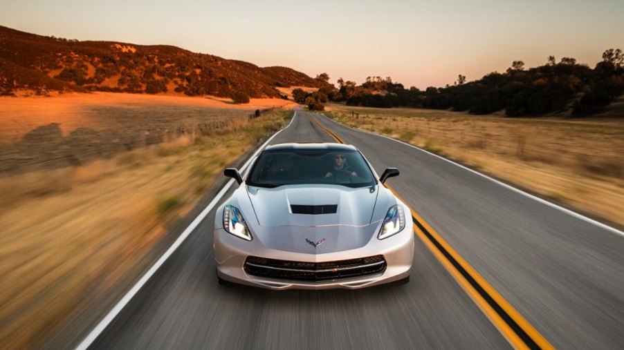 A 2014 model year Chevrolet Corvette C7 Stingray cruises a desert road.