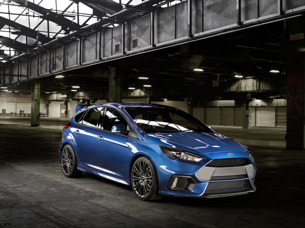 A blue 2016 Ford Focus RS parked in a warehouse