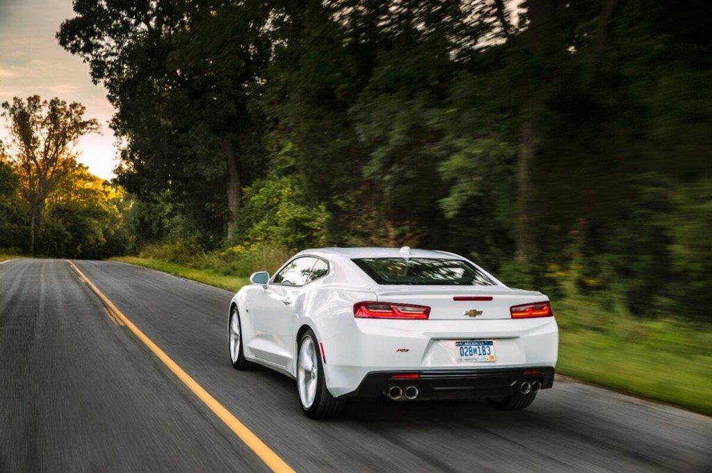 A sixth-generation 2017 Chevrolet Camaro drives down a country road. 