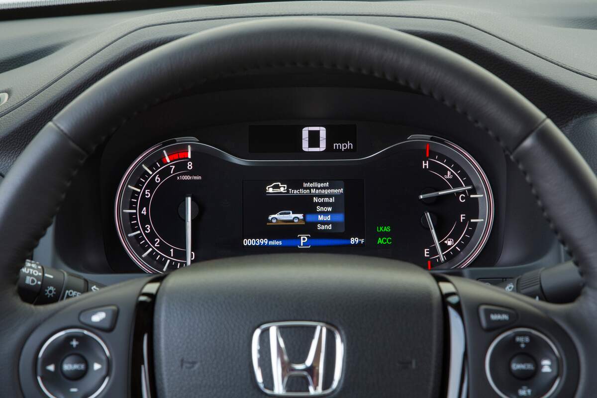 A close-up of a 2017 Honda Ridgeline's instrumentation panel behind the steering wheel