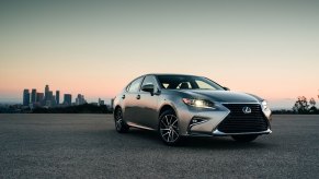 A 2018 Lexus ES 350 parks in a car lot ahead of a nice sunset in LA.