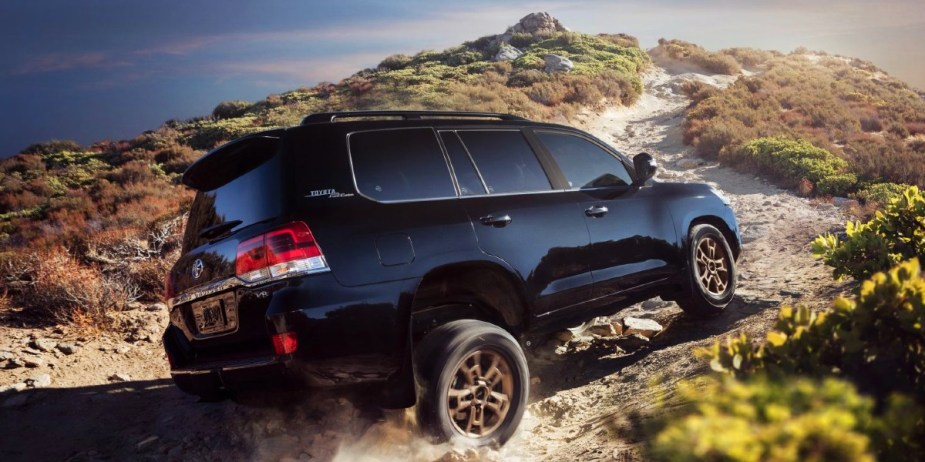 A blue 2021 Toyota Land Cruiser is driving off-road. 