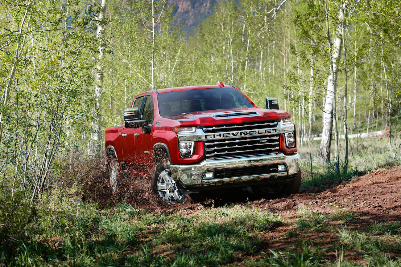 Red 2022 Chevy Silverado 2500 HD parked in the forest