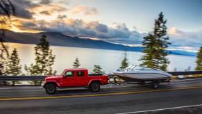 Jeep Gladiator pulling a trailer with a boat on it.