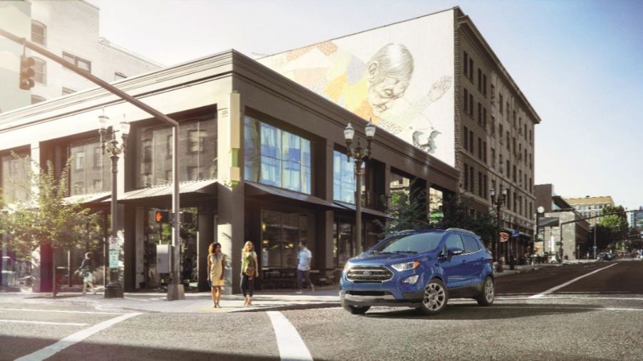 A blue 2022 Ford EcoSport driving in a city.