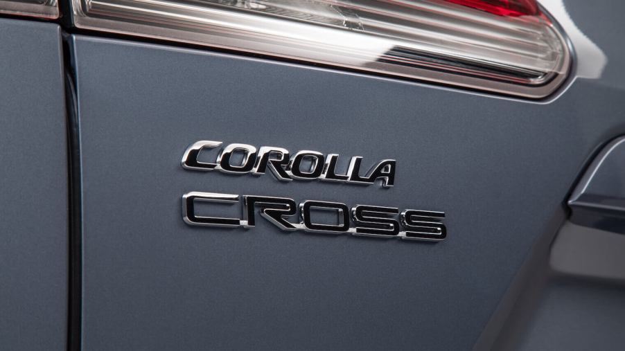 The rear badge of the 2022 Toyota Corolla Cross in gray.