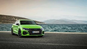 A lime green 2023 Audi A3 Sedan parked by the water