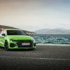 A lime green 2023 Audi A3 Sedan parked by the water