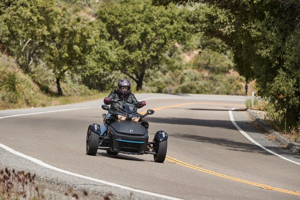 The 2023 Can-Am Spyder comign around a curve