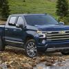The 2023 Chevy Silverado Duramax off-roading in a rocky river bed