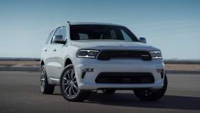 A white 2023 Dodge Durango Citadel parked on asphalt on a cloudless day.