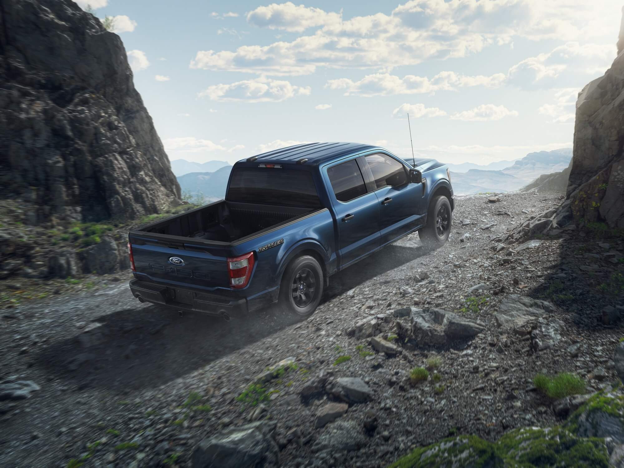 The 2023 Ford F-150 with one cab configuration climbing up a mountain