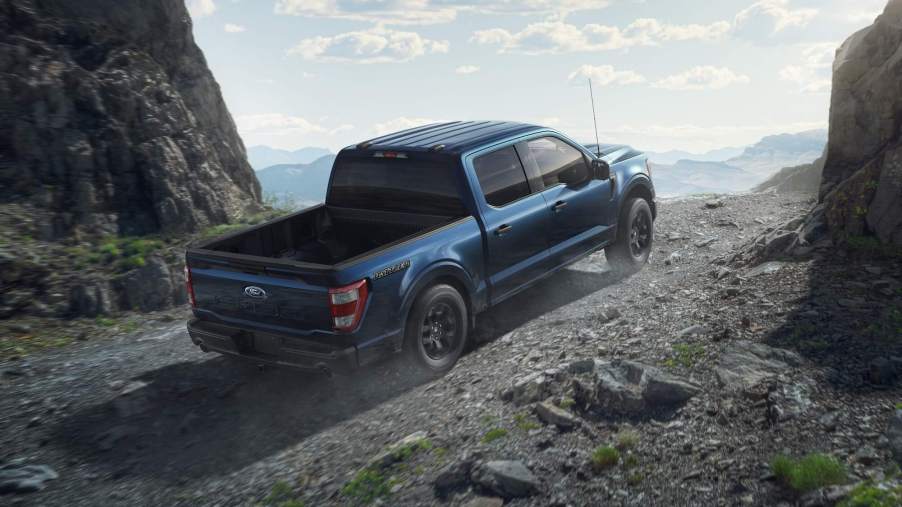 The 2023 Ford F-150 with one cab configuration climbing up a mountain