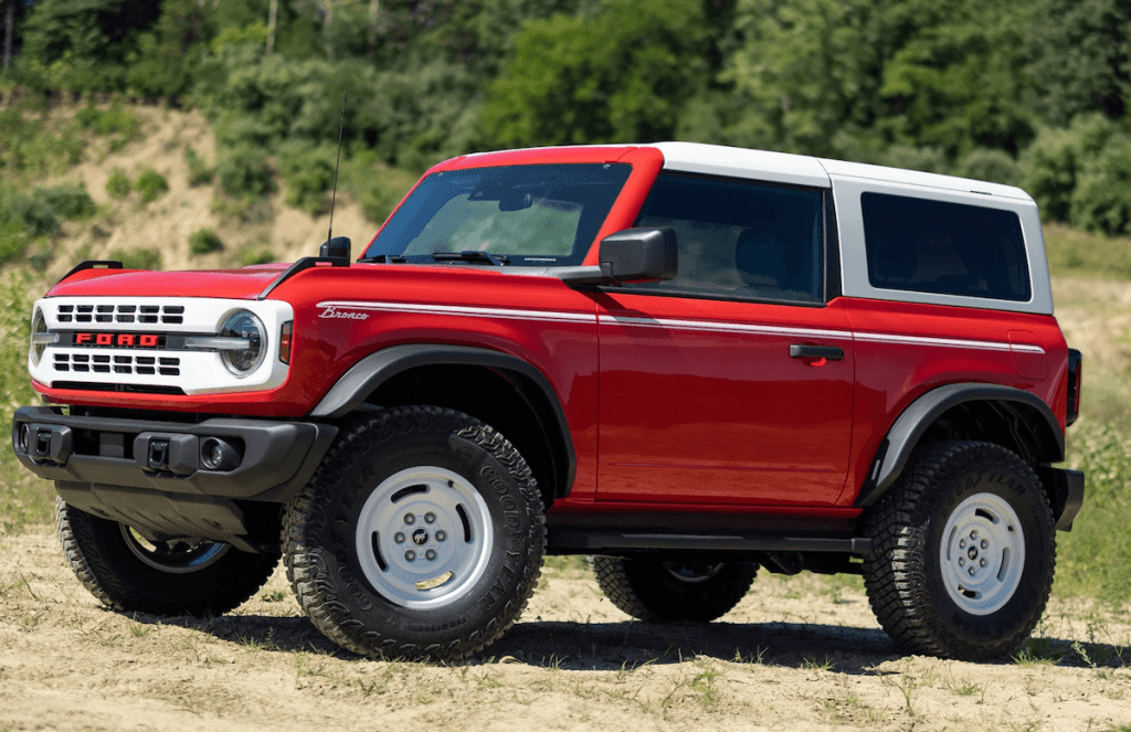 Red and white 2023 Ford Bronco parked on sand