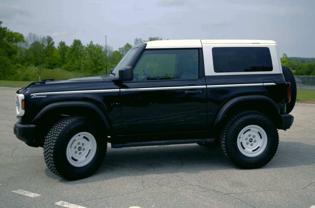 Side profile view of a black 2023 Ford Bronco Heritage Edition. 